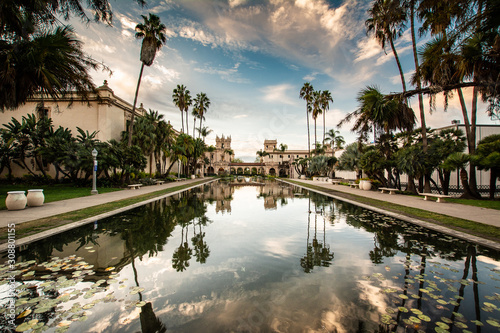 Casa de Balboa, palm trees, and sky reflected in the lily pond at balboa park, san diego, california photo