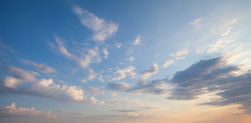 Blue sky clouds background. Beautiful landscape with clouds and orange sun on sky