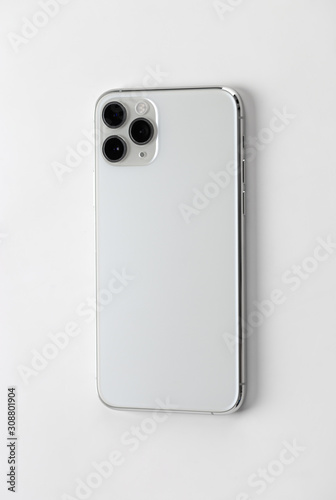 Smartphone with three cameras on a white background.