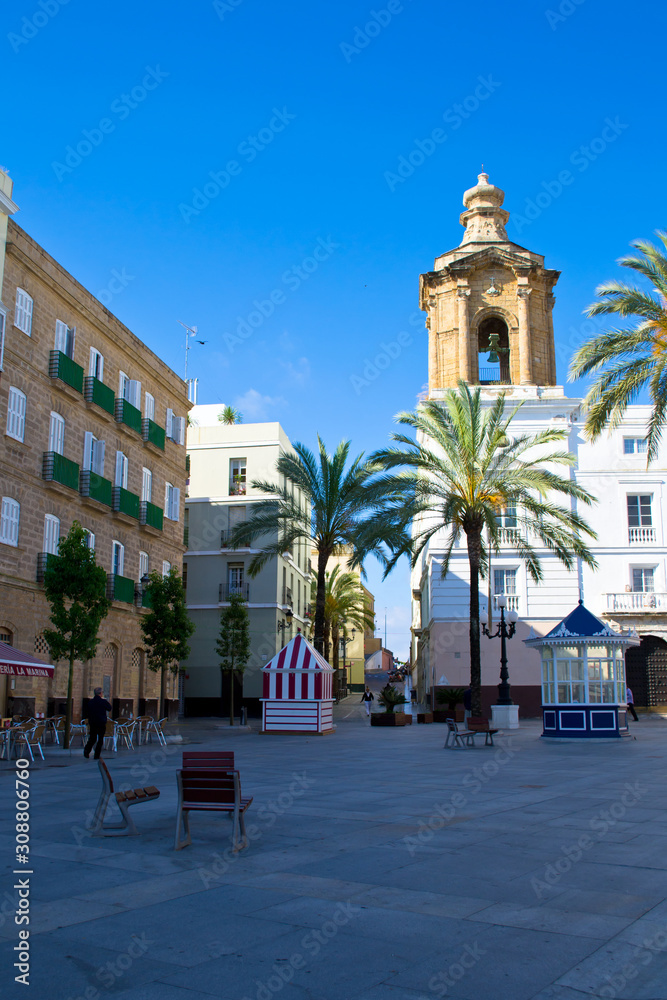 Historical building of Town Hall with a clock tower, columns and arcade, Plaza de San Juan de Dios, Cadiz, Spain.