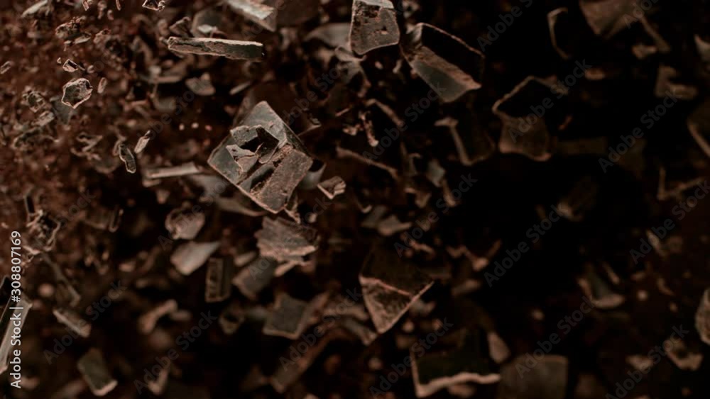 Super Slow Motion Shot of Raw Chocolate Chunks and Cocoa Powder after Being Exploded Towards The Camera at 1000fps. Super Slow Motion Shot of Raw Chocolate Chunks and Cocoa Powder after Being Exploded Towards The Camera at 1000fps.