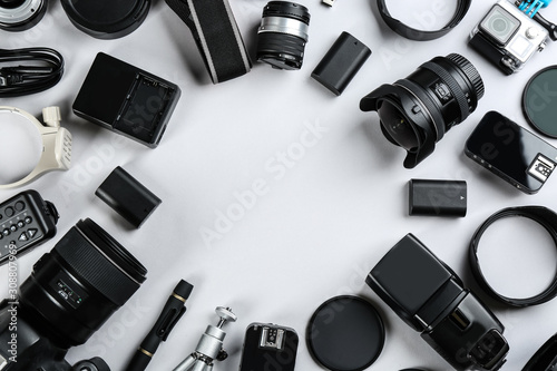 Frame made of equipment for professional photographer on white background, flat lay. Space for text