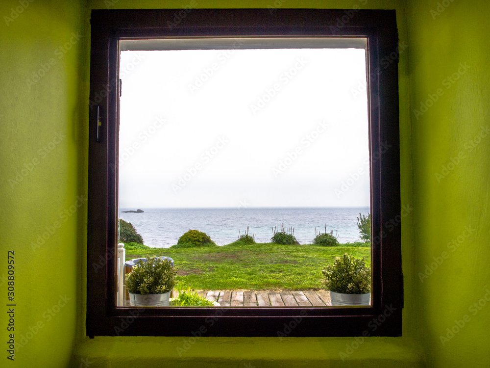 Sea view from a window in a green room Sea view from a window in a green room