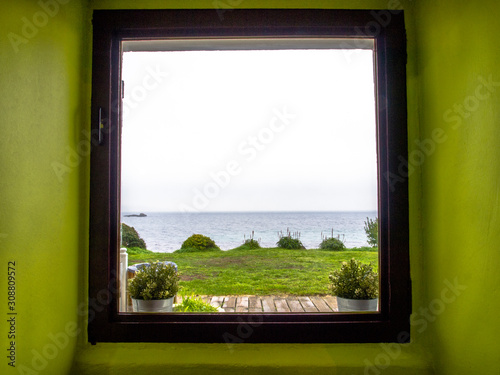 Sea view from a window in a green room