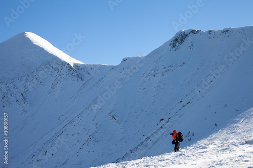 Photographer make photo in snowy mountains