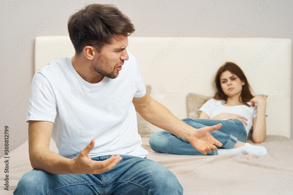 happy couple sitting on sofa and watching tv happy couple sitting on sofa and watching tv