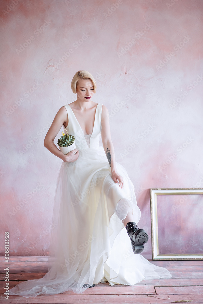 Fashionable, beautiful bride with an unusual flower in her hand. Fashionable, beautiful bride with an unusual flower in her hand.