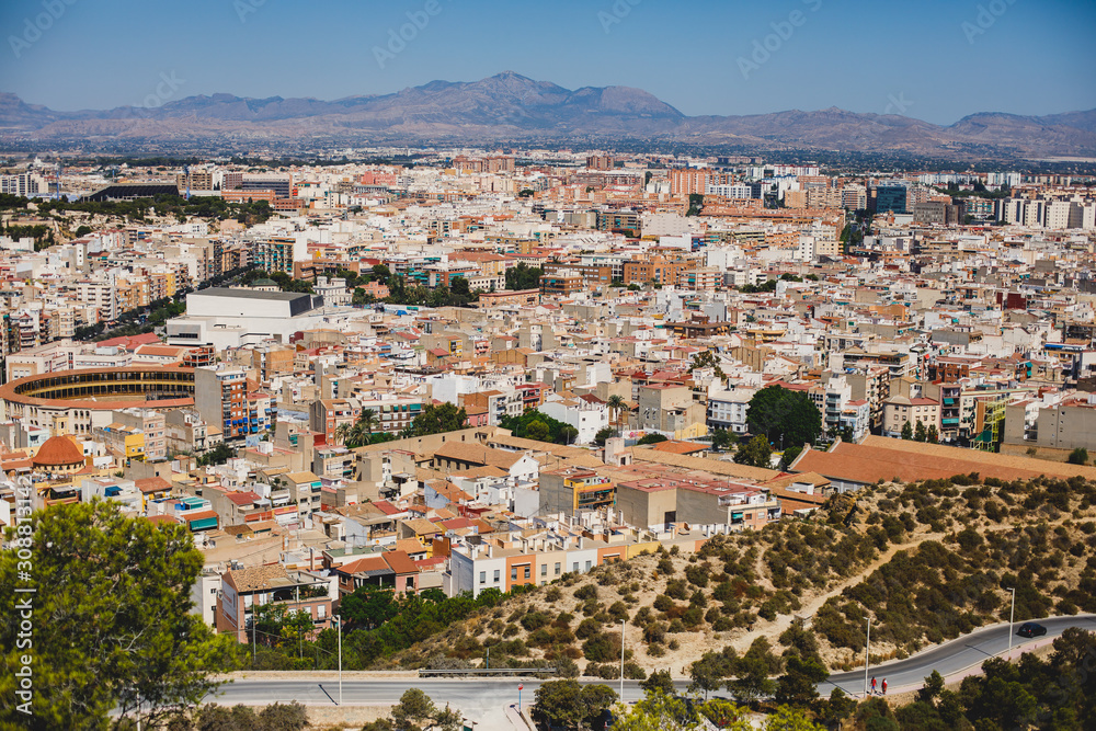 Beautiful wide aerial view of Alicante, Valencian Community, Spain with port of Alicante, beach and marina, with mountains and skyline, seen from Santa Barbara Castle on Mount Benacantil, sunny day