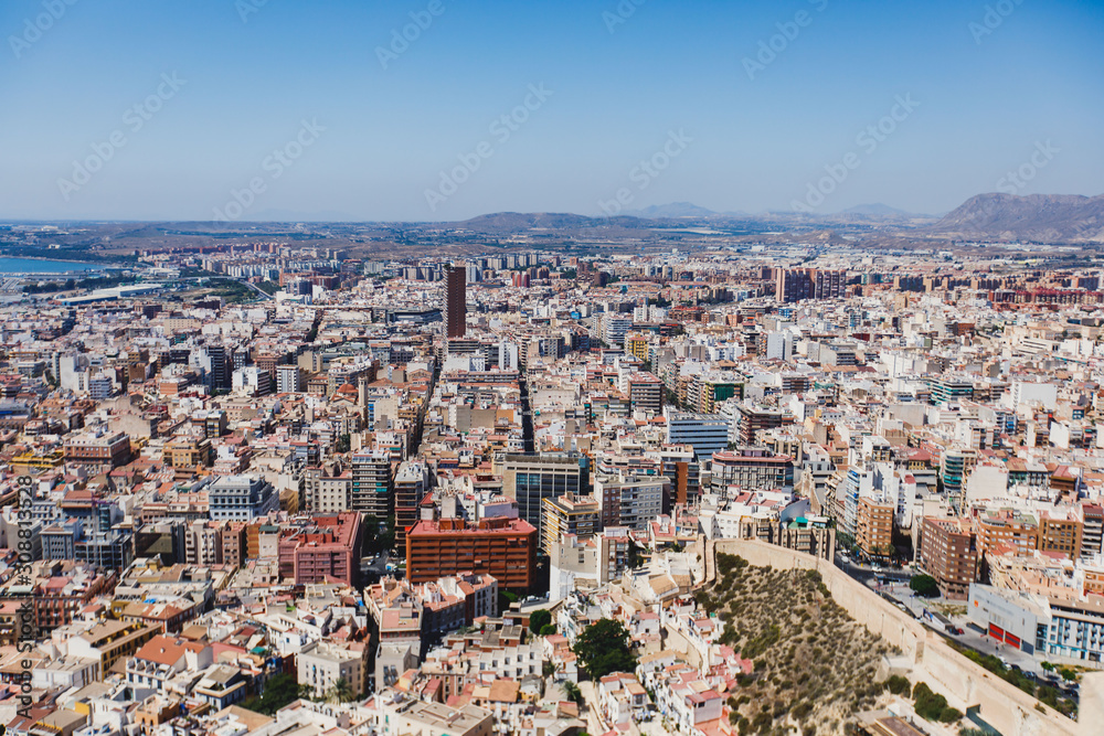 Beautiful wide aerial view of Alicante, Valencian Community, Spain with port of Alicante, beach and marina, with mountains and skyline, seen from Santa Barbara Castle on Mount Benacantil, sunny day