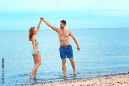 Happy couple dancing at sea...