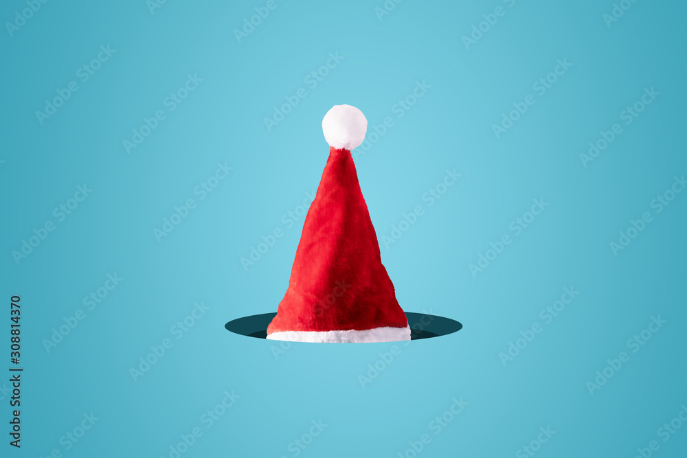 Creative Santa Claus hat over blue background. Minimal winter Christmas concept. Merry Christmas. Creative Santa Claus hat over blue background. Minimal winter Christmas concept. Merry Christmas.