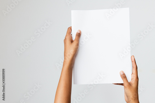 Woman of color holding a letter size or A4 brochure mockup