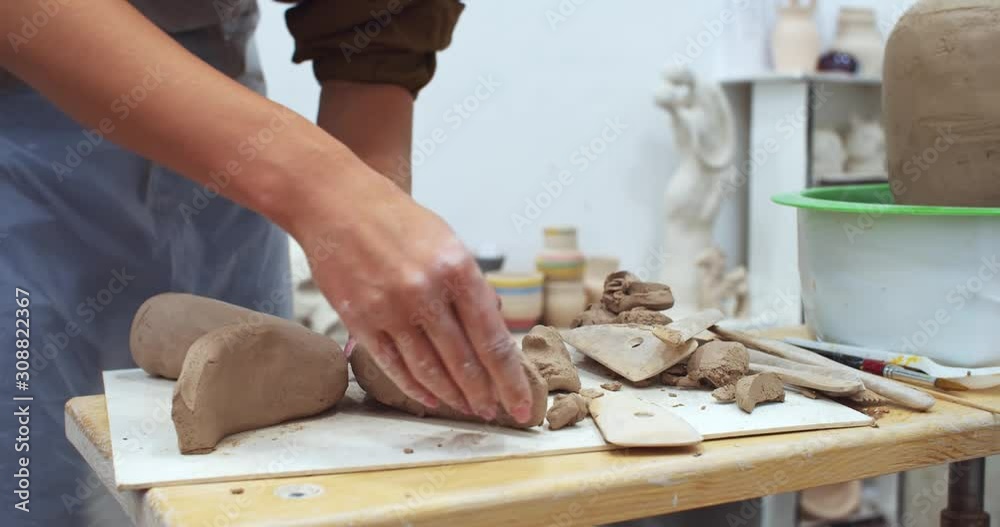 Closeup view of beautiful young girl hands modeling making craft sculpture on wooden pottery table in art classroom. Freelance educating lifestyle. Learning handmade online. Souvenir business. Closeup view of beautiful young girl hands modeling making craft sculpture on wooden pottery table in art classroom. Freelance educating lifestyle. Learning handmade online. Souvenir business.