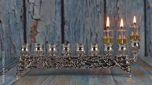 Second day of Hanukkah with burning Hanukkah candles in Hanukkiah traditional Candelabra photo