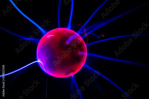 ball with electric neon pulses on a dark background, blur, selective focus