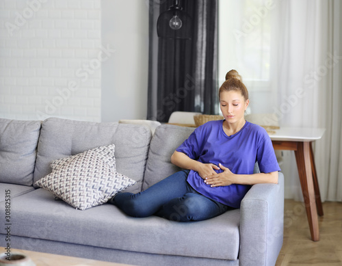 Portrait of young woman suffering from ache. 