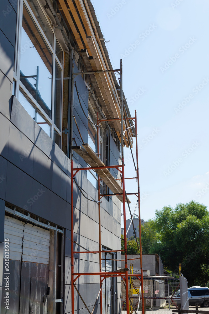 Repair of the facade of a building with installed scaffolding
