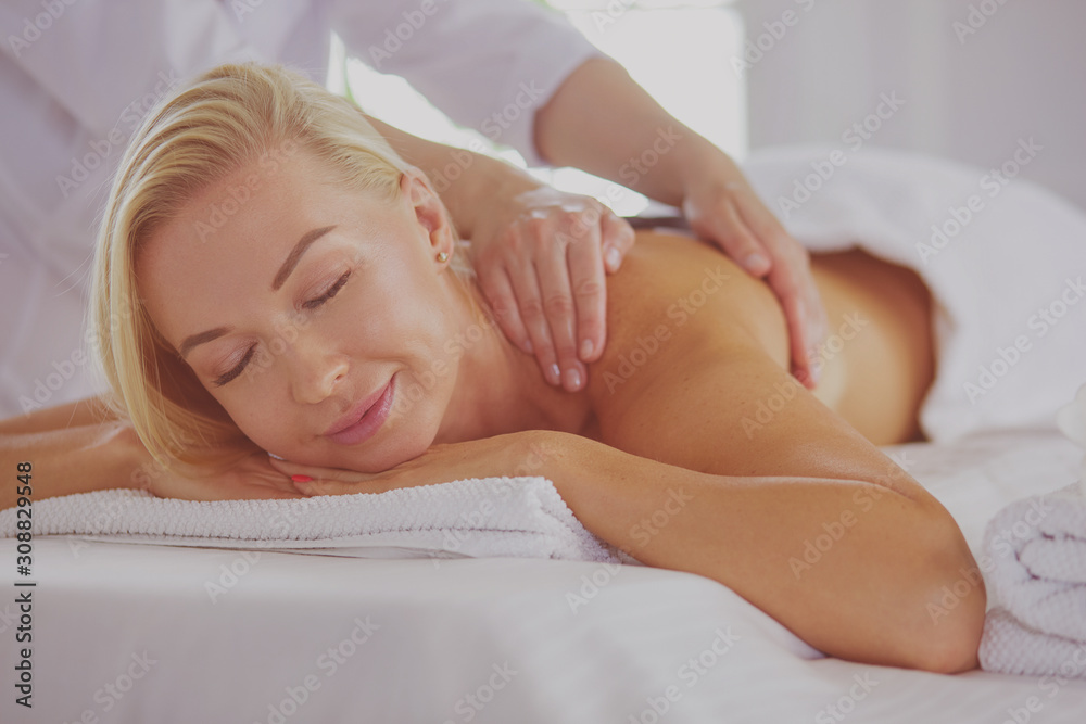 Young woman enjoying massage in spa salon Young woman enjoying massage in spa salon