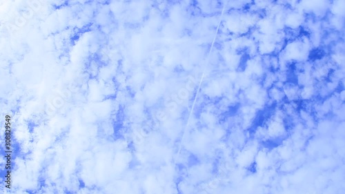 Looking up at a geoengineered sky. Layers of fake clouds drift in the wind. Bottom layer of homomutatus clouds that have spread out and the top layer holds chemtrails that have just been sprayed. photo