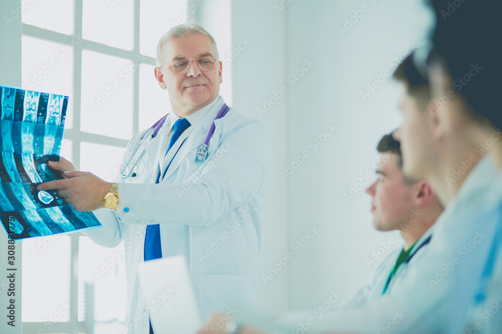 Medical team sitting and discussing at table Medical team sitting and discussing at table