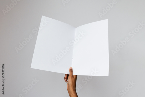 Ethnic model holding a letter size or A4 brochure mockup