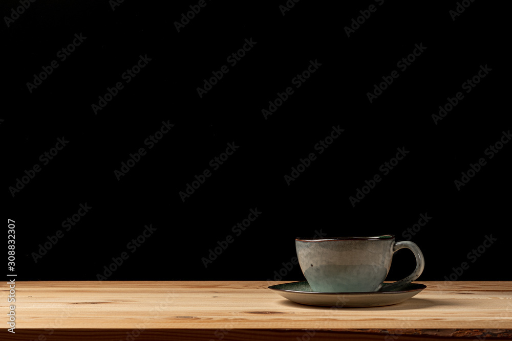 Handmade cup with coffee on the table. Countertop made of wood. Coffee beans. Black background. Handmade cup with coffee on the table. Countertop made of wood. Coffee beans. Black background.