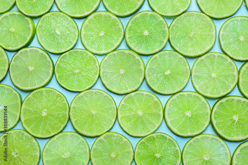 Juicy fresh lime slices on light blue background, flat lay Juicy fresh lime slices on light blue background, flat lay
