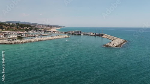 Wallpaper Mural Aerial view above small fishing boat leaving Arenys de Mar, Spain harbour. Amazing turquoise ocean water peaceful promenade. Torontodigital.ca