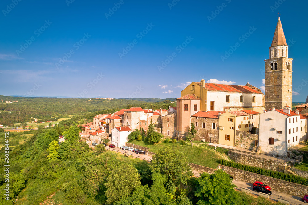Old stone town of Buje on green hill aerial view