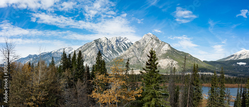 Panorama of Canadian rockies with trees and clouds 