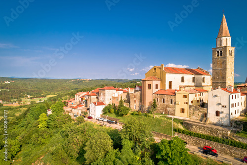 Old stone town of Buje on green hill aerial view