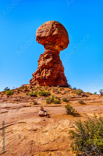 Balanced Rock, a tall and delicate sandstone Rock Formation in the desert landscape of Arches National Park near Moab in Utah, United States