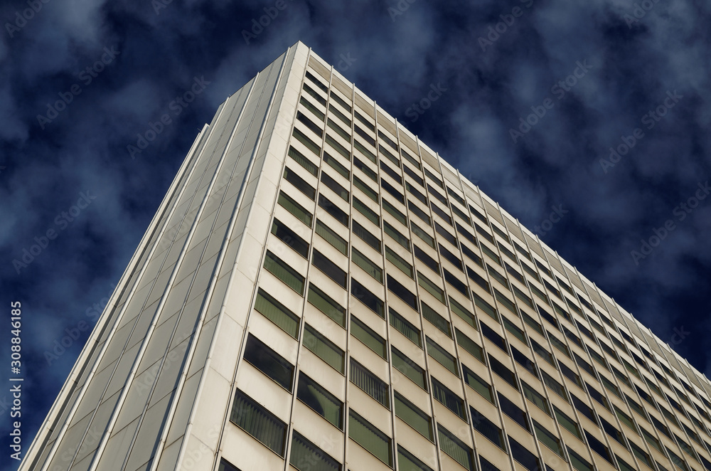 white office building against deep blue cloudy sky in cologne white office building against deep blue cloudy sky in cologne