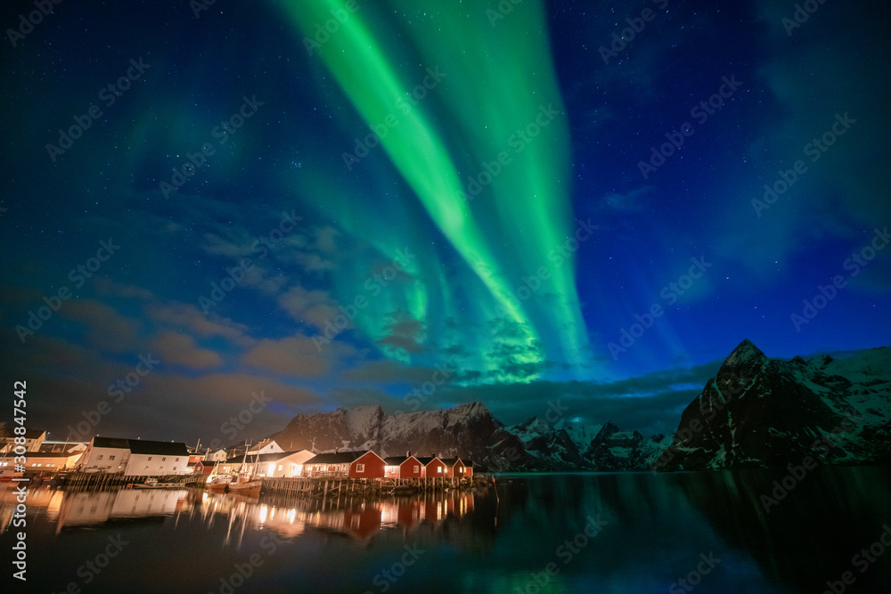 Aurora borealis on the Lofoten islands, Norway. Green northern lights above mountains. Night sky with polar lights. Night winter landscape