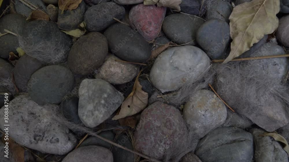 Colorful stones on the ground with Dry leaf and some Wool, Pattern Stone Colorful stones on the ground with Dry leaf and some Wool, Pattern Stone