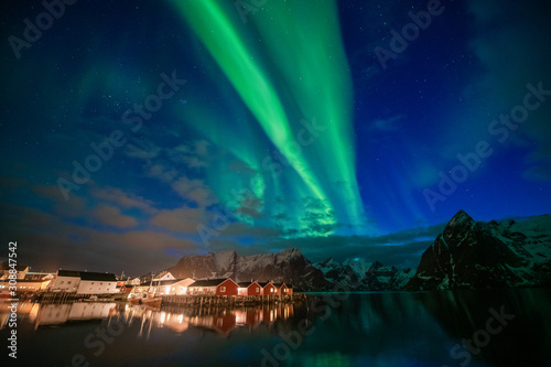 Aurora borealis on the Lofoten islands  Norway. Green northern lights above mountains. Night sky with polar lights. Night winter landscape