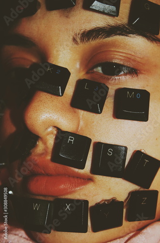 Close up of keyboard keys on woman's face photo