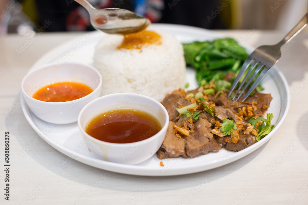 Selective focus of Roast beef  on rice Thai style