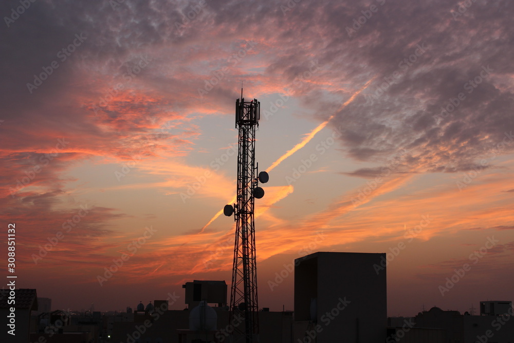 mobile cellular wireless communication antenna tower - beautiful sunset sky view