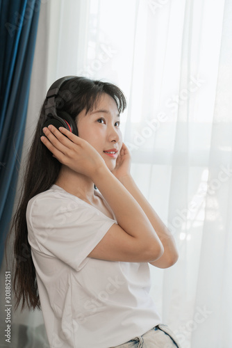 asian young woman listen to the music at home