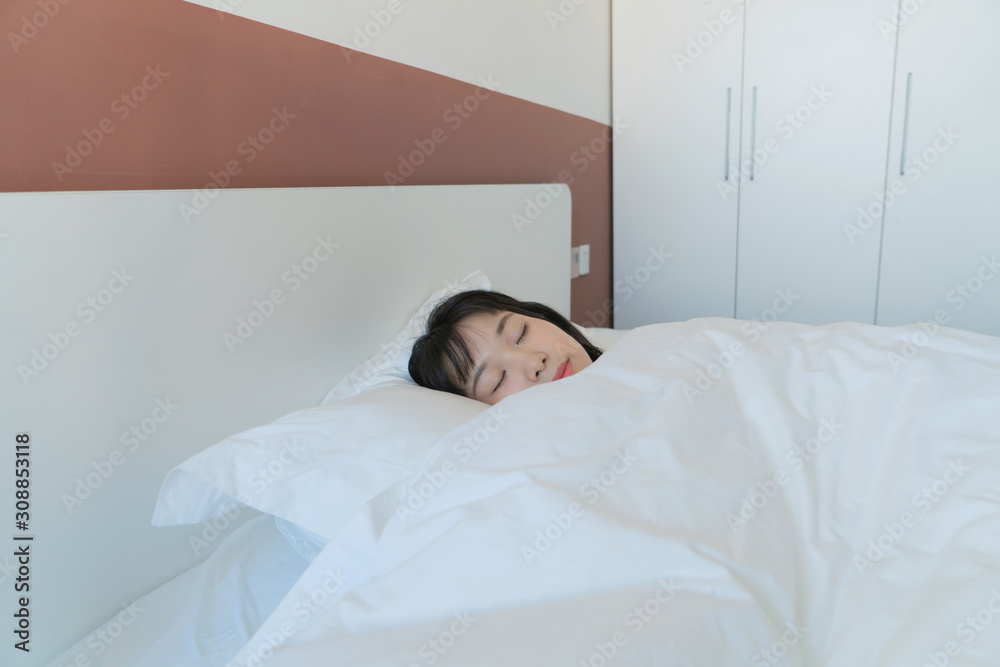 asian Young beautiful woman sleeping in her bed and relaxing in the morning asian Young beautiful woman sleeping in her bed and relaxing in the morning