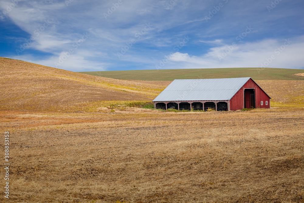 A red barn with graphic hills of the Palouse in Washington state, USA A red barn with graphic hills of the Palouse in Washington state, USA