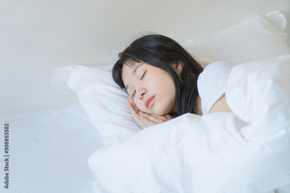 asian Young beautiful woman sleeping in her bed and relaxing in the morning asian Young beautiful woman sleeping in her bed and relaxing in the morning