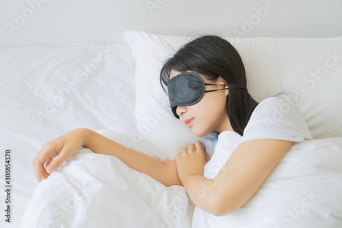 asian young beautiful woman sleeping in bed with eye mask