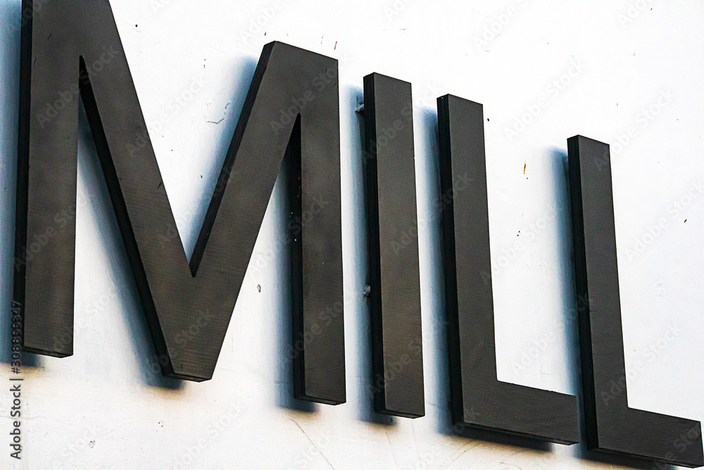 sign-large-dynamic-bold-letters-spelling-the-word-mill-stock-photo