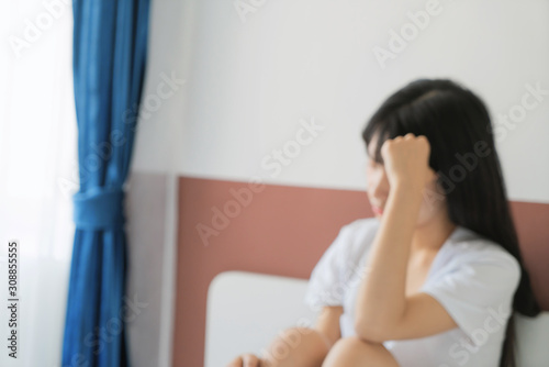 Single beautiful woman sad and lonely in bedroom