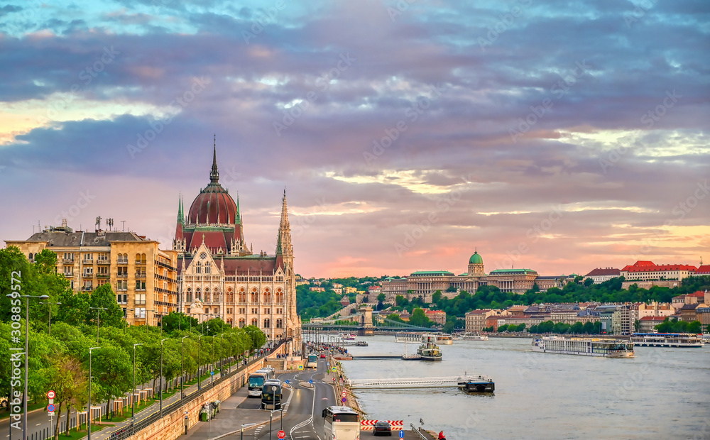 The Hungarian Parliament Building located on the Danube River in Budapest Hungary at sunset.