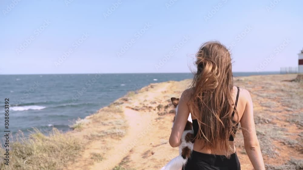 Young adult girl spending summer day together with little chihuahua Young adult girl spending summer day together with little chihuahua