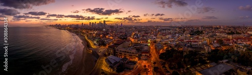 Aerial view of Tel Aviv Yafo along the Mediterranean sea at predawn with colorful sky over the city in Israel