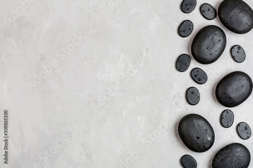 Top view of hot spa stones set for massage treatment on gray concrete background with copy space. Elegant and luxury spa. Flat lay, overhead, mock up, template. Health and beauty care concept